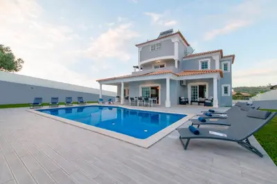 two beds in a room with a window at Villa Ocean by Algarve Vacation in Albufeira
