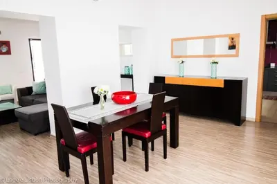 a living room with a table and chairs and a couch at Villa Azul in Boliqueime