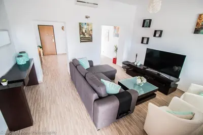 a living room with a couch and a tv at Villa Azul in Boliqueime