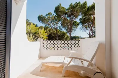 a person is looking at a cactus at Acolhedor Apt T1, vista piscina , Balaia Golf Village in Albufeira