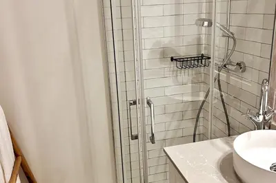 a bathroom with a shower and a sink at Stunning beach apartment in Almancil