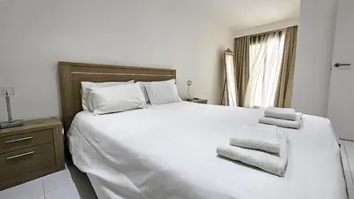 a bedroom with a large white bed with towels on it at Albufeira, Blue Wave Retreat 65 in Albufeira