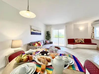 a living room with a table with food on it at Albufeira Balaia Golf Vilage 7 With Pool by Homing in Albufeira
