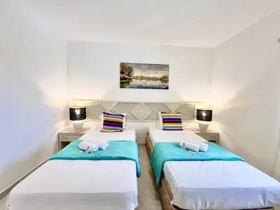 two beds in a room with two lamps at Albufeira Balaia Golf Vilage 7 With Pool by Homing in Albufeira