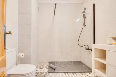 a bathroom with a shower and a toilet at Nature Escape 2BR Villa Pool Wi-Fi AC in Olhos de Água