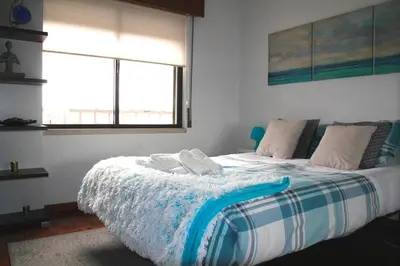 a bedroom with a bed with towels on it at Brigida's Flat in Faro