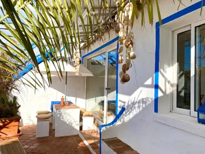 a house with solar panels on the roof at Casa da Aldeia in Santa Bárbara de Nexe