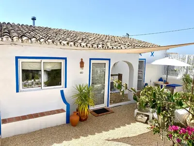 a swimming pool in a backyard with a fence at Casa da Aldeia in Santa Bárbara de Nexe