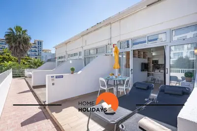 a house with a balcony with a table and a patio at #255 Oura Cilla by Home Holidays in Albufeira