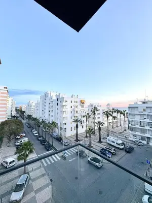 a view of a street with parked cars and buildings at Terracos de Quarteira II White by Real Properties in Cavacos