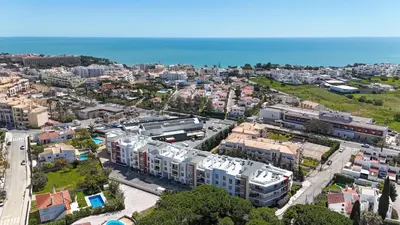 an aerial view of a city with buildings and the ocean at Medronheira - Apt 1A by HelloVacations in Albufeira