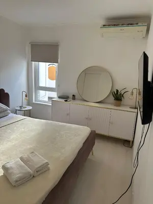 a bedroom with a large bed and a mirror at Vilamoura Modern House in Quarteira