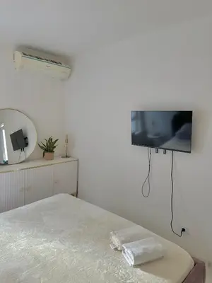 a bedroom with a bed with a tv on the wall at Vilamoura Modern House in Quarteira