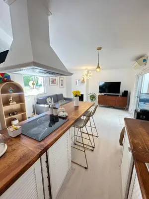 a kitchen and living room with a counter top at Vilamoura Modern House in Quarteira