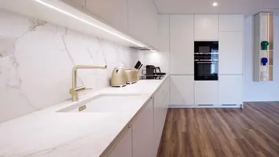 a white kitchen with a sink and a stove at Orange Boutique Residence - Casa Farol Adults Only in Quarteira