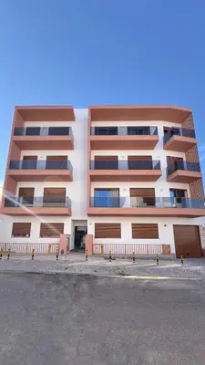 an apartment building with brown and white at Orange Boutique Residence - Casa Farol Adults Only in Quarteira