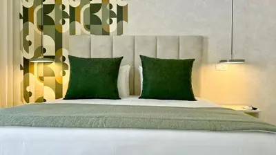a bedroom with a large bed with green pillows at Orange Boutique Residence - Casa Farol Adults Only in Quarteira