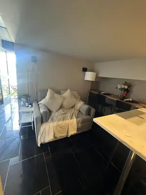 a living room with a bed and a table at Beach Holidays in Quarteira