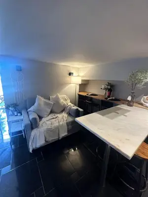 a living room with a bed and a table at Beach Holidays in Quarteira