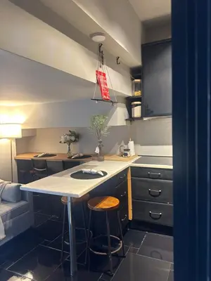 a kitchen with a counter and some stools in it at Beach Holidays in Quarteira