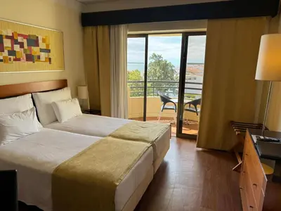 a hotel room with a bed and a balcony at Hotel Vila Galé Cerro Alagoa in Albufeira