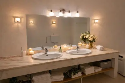 a bathroom with two sinks with candles and a mirror at Ocean Bliss - Panoramic Sea View - 20m to Beach - 2 Swimming Pools - Private Parking in Albufeira