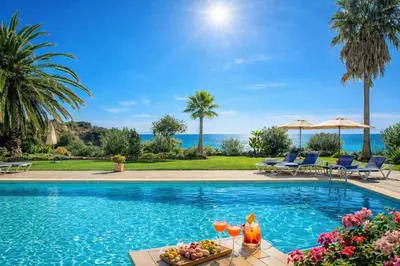 a swimming pool with a table with fruit and drinks on it at Ocean Bliss - Panoramic Sea View - 20m to Beach - 2 Swimming Pools - Private Parking in Albufeira