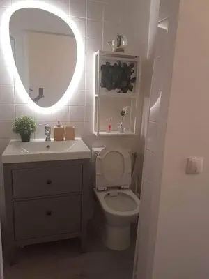 a bathroom with a toilet and a sink and a mirror at House e Beach in Albufeira