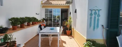 a patio with a table and chairs on a balcony at Albufeira Home Paderne in Paderne