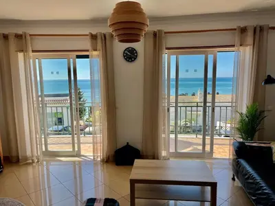 a living room with a view of the ocean at Hofnar Sea View Apartment in Albufeira