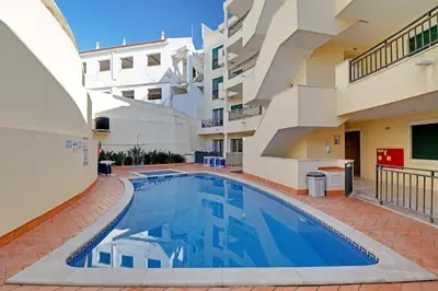 a swimming pool in the courtyard of a building at Hofnar Sea View Apartment in Albufeira