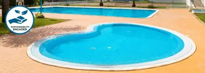 a large blue swimming pool with a sign next to it at Apartment Curitiba by Algarve Vacation in Albufeira