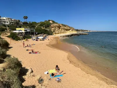 a group of people on a beach near the water at Villa Ana in Albufeira
