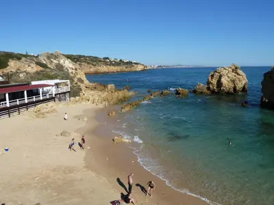 a group of people on a beach near the water at Villa Ana in Albufeira