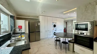 a large kitchen with a sink and a counter top at Ocean Drive by Check-in Portugal in Albufeira
