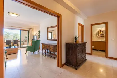 a living room with a desk and a mirror at Vilamoura Residence in Quarteira