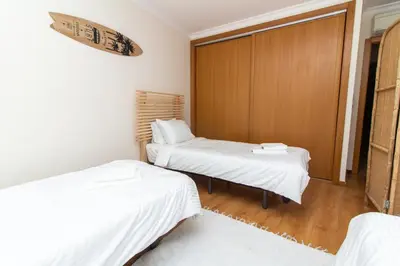 two beds in a room with white sheets at Old Town Boho Seaview Elegance in Albufeira