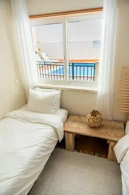 a room with two beds and a window at Old Town Boho Seaview Elegance in Albufeira