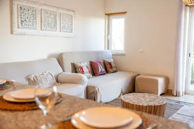 a living room with a couch and a table at Old Town Boho Seaview Elegance in Albufeira
