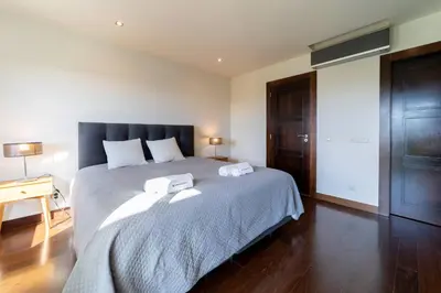 a bedroom with a large bed with two towels on it at Villa Colina - A1 by HelloVacations in Albufeira