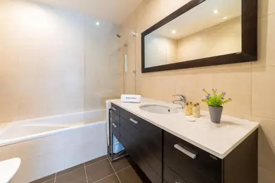 a bathroom with a sink and a bath tub at Villa Colina - A1 by HelloVacations in Albufeira