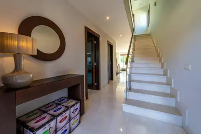 a staircase in a house with a mirror on the wall at Villa Colina - A1 by HelloVacations in Albufeira