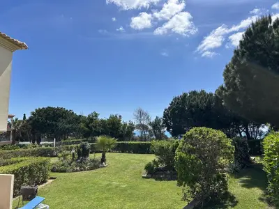 a garden with bushes and trees on a sunny day at Moradia B - 200m da Praia da Oura - Leste in Albufeira