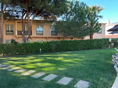 a building with trees and a grass yard at Moradia B - 200m da Praia da Oura - Leste in Albufeira