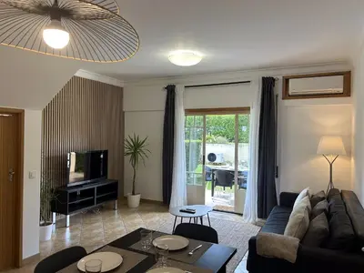 a living room with a couch and a table at Moradia B - 200m da Praia da Oura - Leste in Albufeira