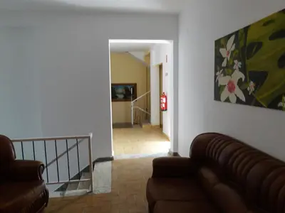 a living room with a couch and a painting on the wall at Residencial Espadinha in Quarteira