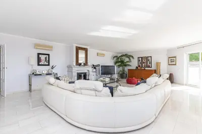 a large white living room with a large white couch at Casa Sonhos in Albufeira