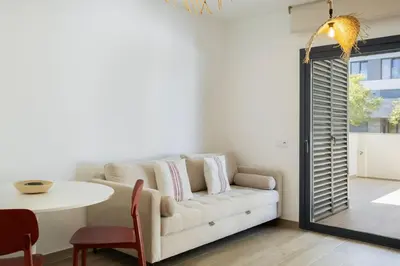 a living room with a white couch and a table at TAC - Alma Apartment in Faro