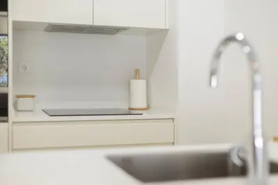 a kitchen counter with a sink and a roll of paper towels at TAC - Alma Apartment in Faro