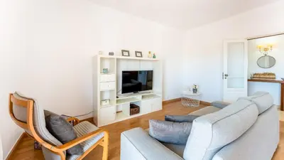 a living room with a couch and a tv at Sunny 3BDR Apt with Pool in Ferreiras by LovelyStay in Albufeira